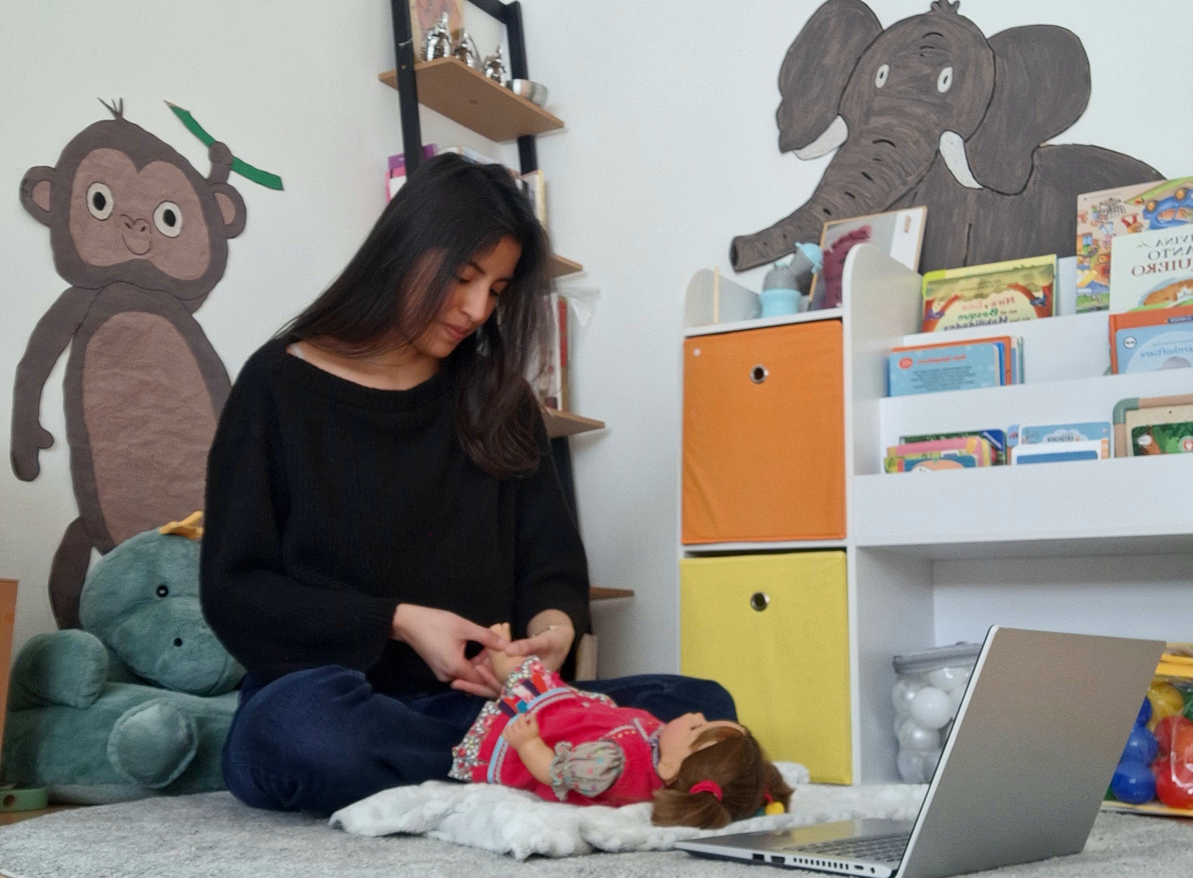 person demonstrating exercises with a doll